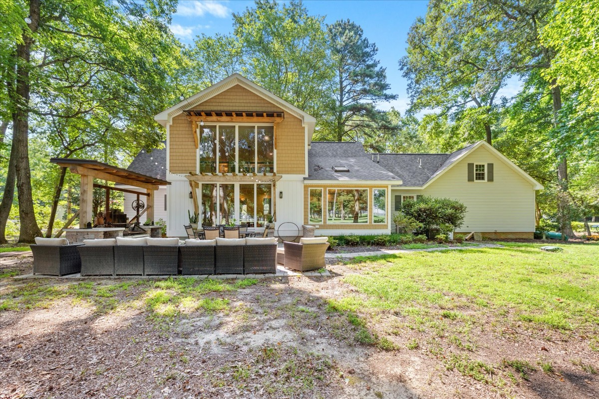 Stunning rear exterior with floor-to-ceiling windows and outdoor entertaining